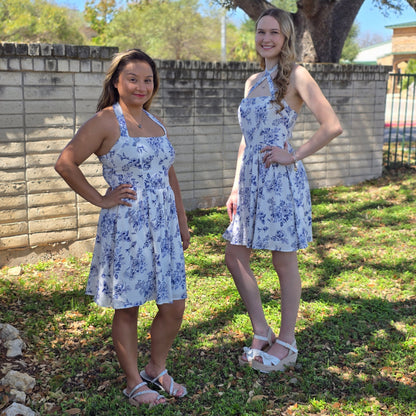 Blue floral mini dress with halter or crisscross neckline. Flowy, feminine, and perfect for spring events, brunch, and everyday style.