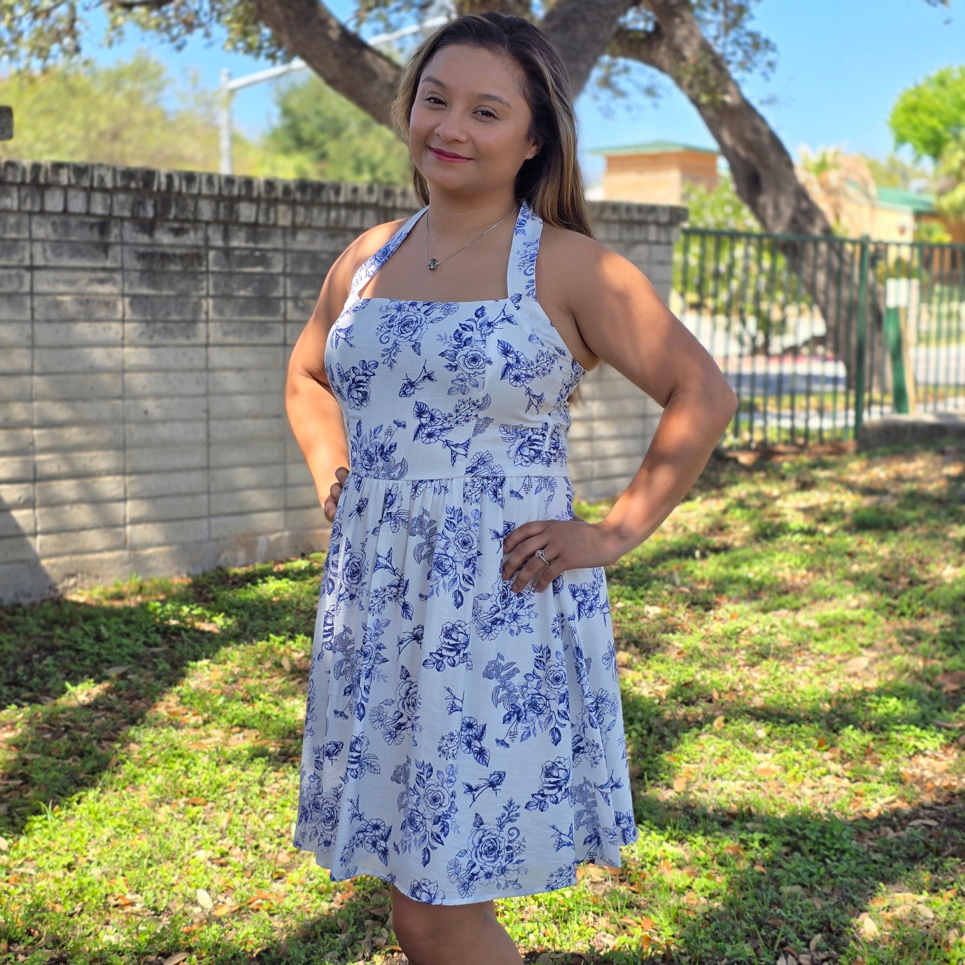Blue floral mini dress with halter or crisscross neckline. Flowy, feminine, and perfect for spring events, brunch, and everyday style.