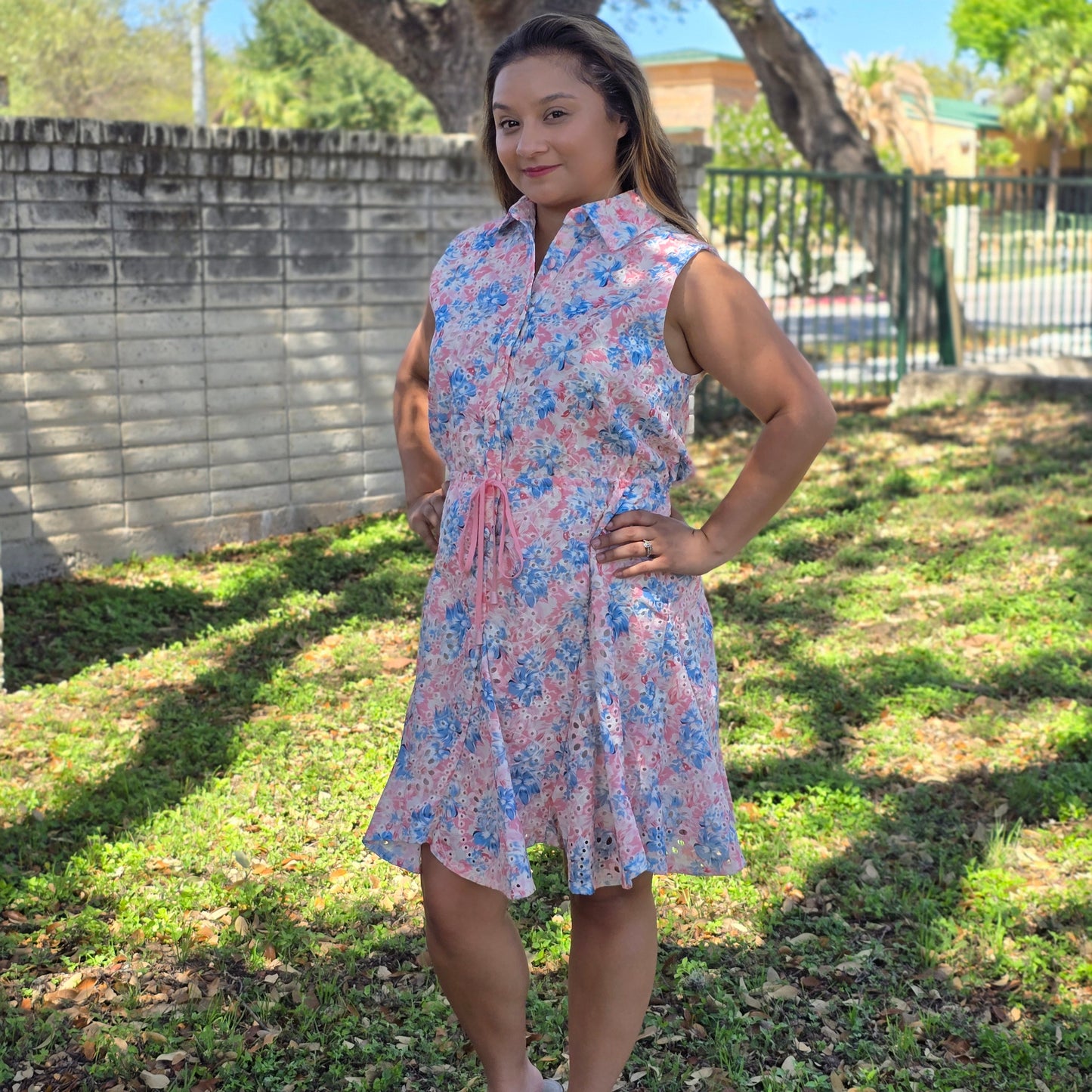 Pink and blue floral shirt dress with tie waist and sleeveless design. Lightweight, flattering, and perfect for brunch, casual days, and spring style.
