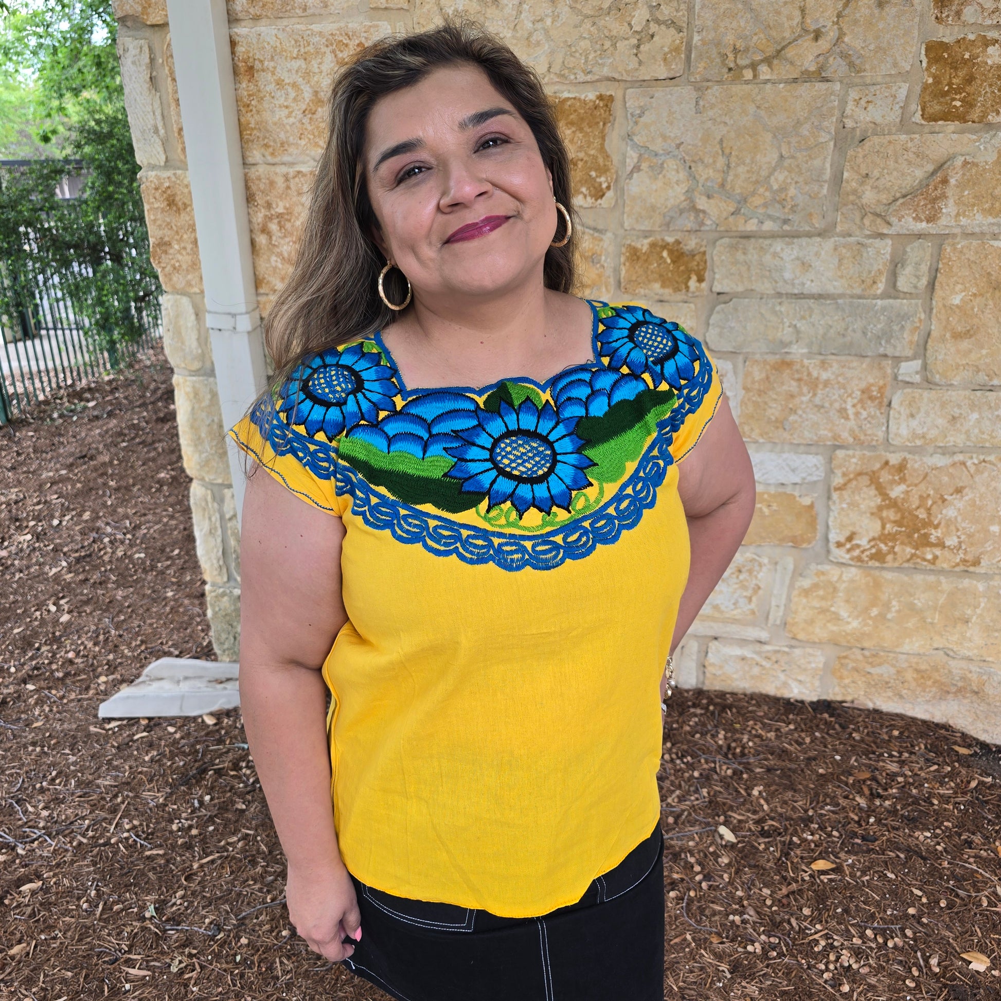 Yellow top with floral patterns.