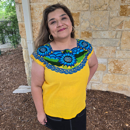 Yellow top with floral patterns.