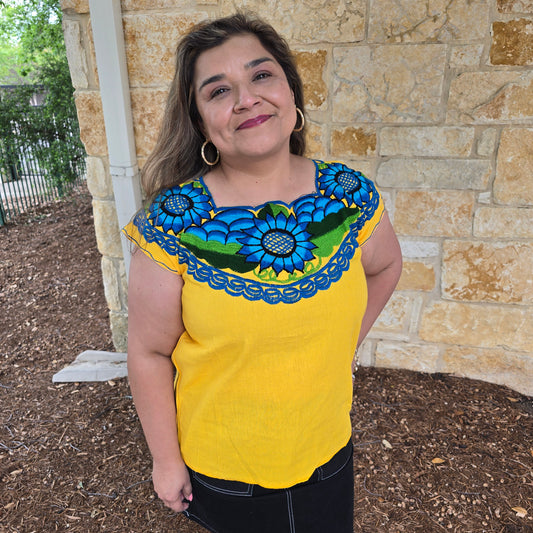 Yellow top with floral patterns.