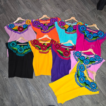 Colorful crop tops with floral embroidery.